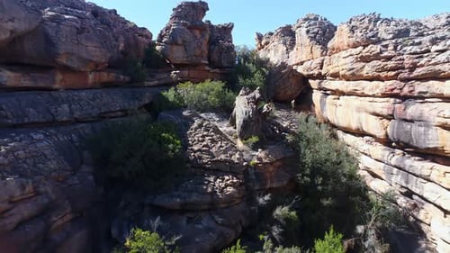 Man Highlining Between Towering Rocks