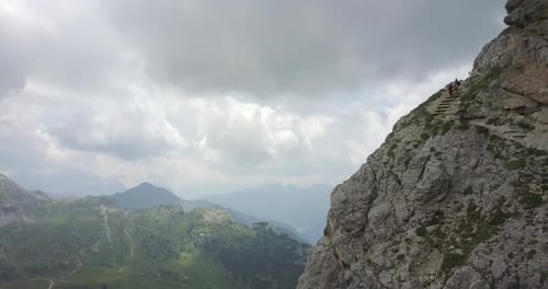 Aerial drone view of a man and woman couple hiking in the mountains