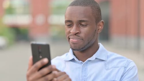 Close Up on Young Man Using Mobile Phone