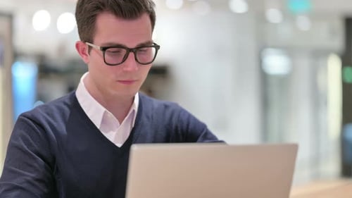Young Businessman Working on Laptop, Close Up