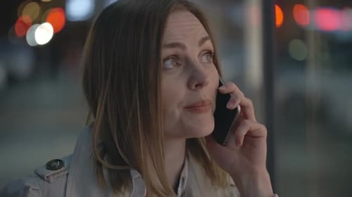 Smiling Woman Talking on Phone at Night