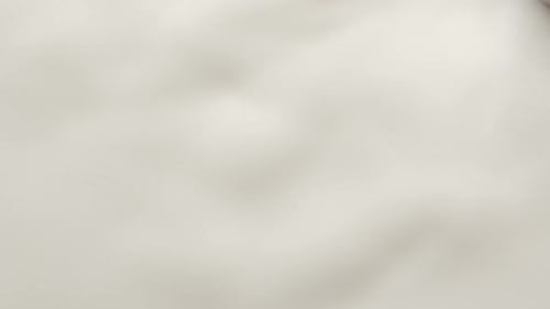 Chocolate Ball Dropping into White Creamy Liquid