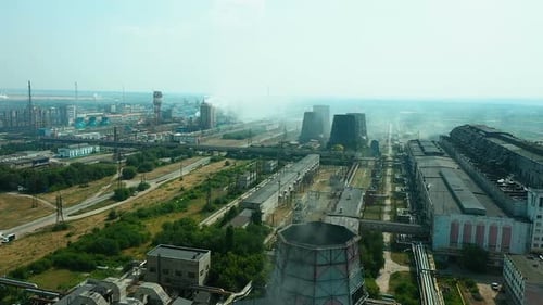 Aerial View, Industrial Area, Plant Area with Huge Exhaust Pipes, Smoke Escapes Into the Air