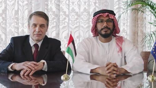 Three Men Seated at Table with Flags