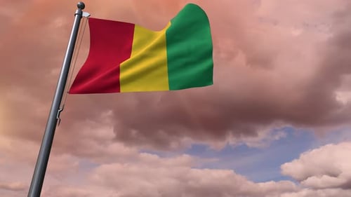 Guinea Flag Waving Against Cloudy Sunset Sky