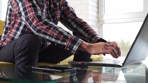 Close-up of hands typing on keyboard.