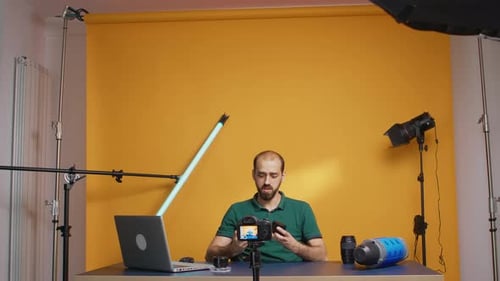 Man Demonstrates Photography Equipment in Studio Setting