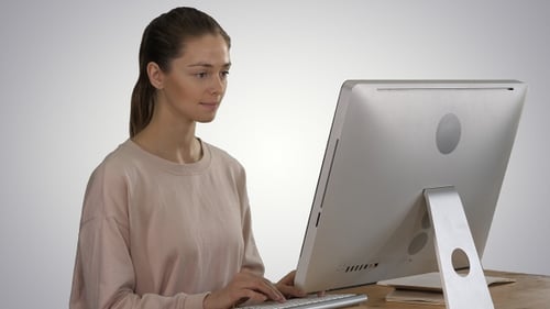 Woman Typing on Computer in Minimalist Office