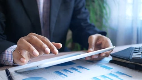 Businessman Using Digital Tablet on Office Desk