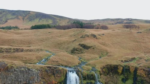 Spectacular Waterfall Cascades Down Rocky Cliff