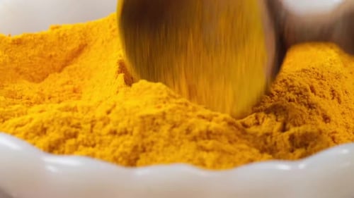 Turmeric Root Powder in Bowl on Table