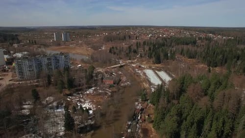 An Aerial View of a Residential Wooded Area on a Bright Day