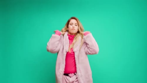 Woman with Blonde Hair Dancing in Pink Outfit