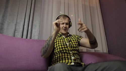 Man Listening to Music on Headphones Dancing