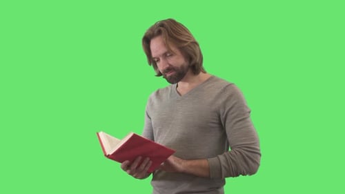 Smiling Man Reading a Book on Green Screen