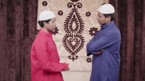 Men in Traditional Clothing Engage in Conversation