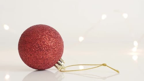 Close-up of bauble with sequins 4K 2160p 30fps UltraHD tilting footage - Red Christmas ornament an