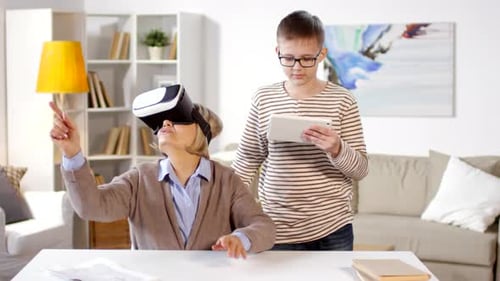 Woman Uses VR Headset with Teenager Helper