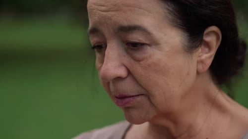 Closeup Desperate Frustrated Senior Woman Looking Away Thinking Standing Outdoors in Park