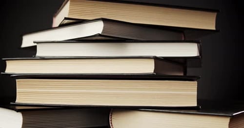 Stack of Hardcover Books in Dim Studio Light