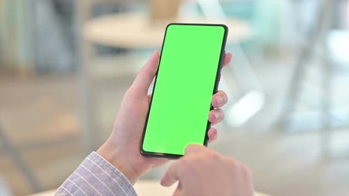 Rear View of Female Hand Using Smartphone with Chroma Screen