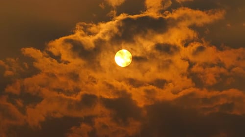 Golden Sun Breaking Through Cumulus Clouds