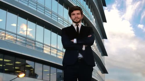 Confident Man Standing Before Modern Office Building