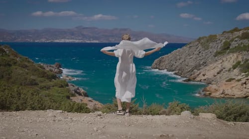 Woman with Scarf on a Scenic Coastline