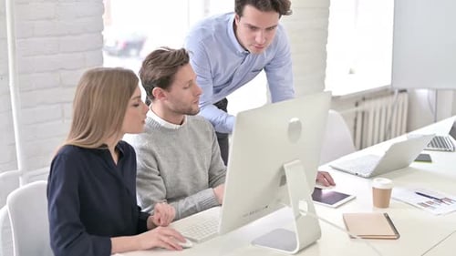Angry Creative Man Discussing with Team and Using Desktop