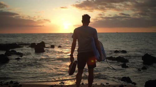 Young Adult on Beach with Body Board at Sunrise