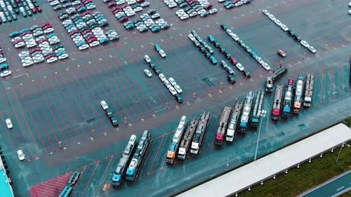 Cars Drive and Park on Huge Open Parking Lot Aerial View