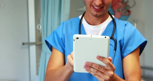 Smiling Healthcare Worker Using Tablet in Hospital Room