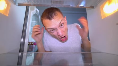 Man Opens Empty Refrigerator, Looks Disappointed
