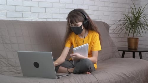 Child Wearing Mask Learning Online at Home