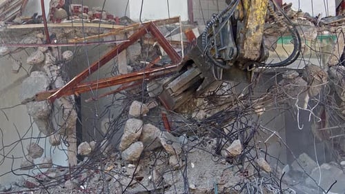 Mechanical Arm Demolishing Building in Urban Environment