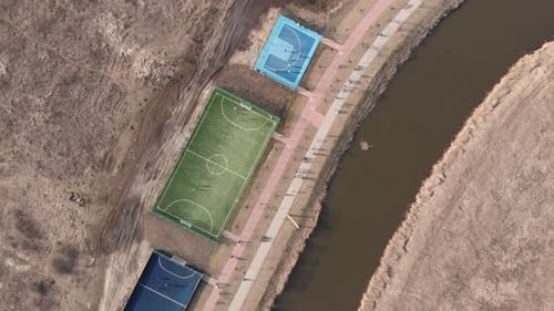 Drone flying over modern sport playground with training area, soccer and basketball fields