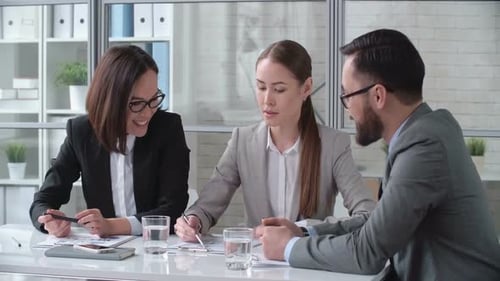 Business Colleagues Discussing Documents in Modern Office