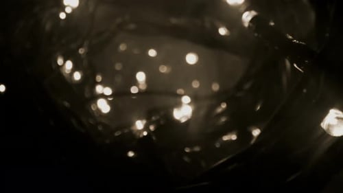 Glowing String Lights Sparkling Abstractly in the Dark