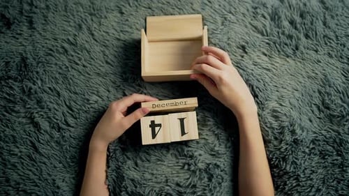 Hands Setting Calendar Date Wooden Block Calendar