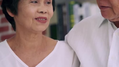 Senior Couple Holding Hands and Smiling Together