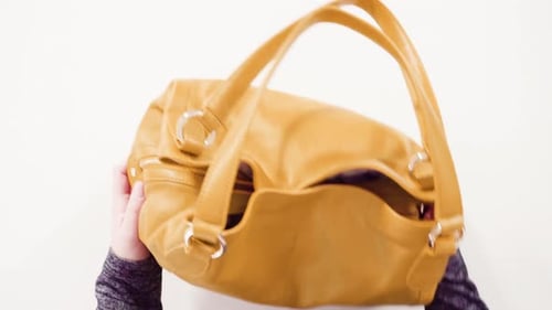 Woman Holding Tan Leather Handbag Close Up
