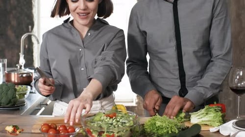 Couple Prepares Salad Together in Bright Kitchen