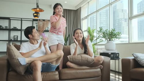 Happy Family Cheering and Clapping for Daughter
