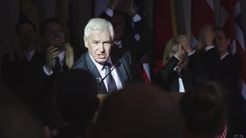 Speaker Giving Political Speech with Supporters Clapping