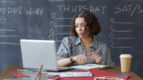20-something Female Freelancer Working on Laptop