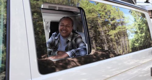 Smiling Woman Looks Out of Camper Van Window