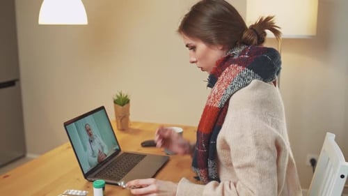 Woman Telehealth Appointment with Doctor Using Laptop