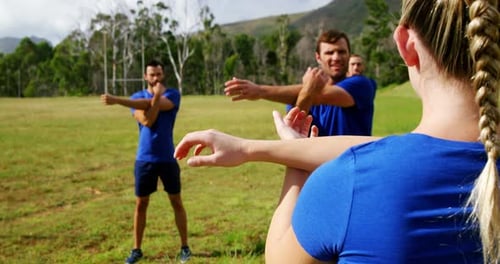 Female trainer training people in boot camp 4k