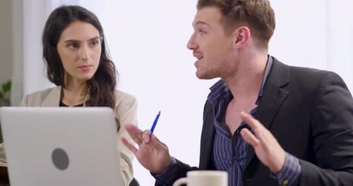 Colleagues Discussing Technology in an Office