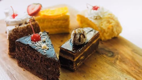 Variety of Delicious Cakes on Wooden Board
